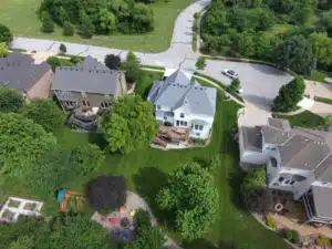 Aerial view of suburban neighborhood homes and lawns.